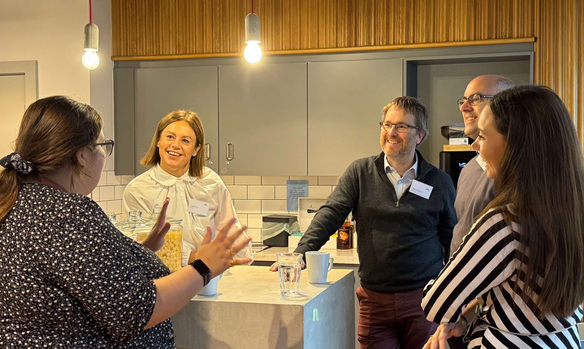 AHR Director and roundtable host Robert Hopkins socialising with event attendees in the kitchen area.