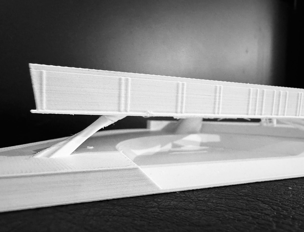 A photograph of a 3d-printed model of a proposed building.
