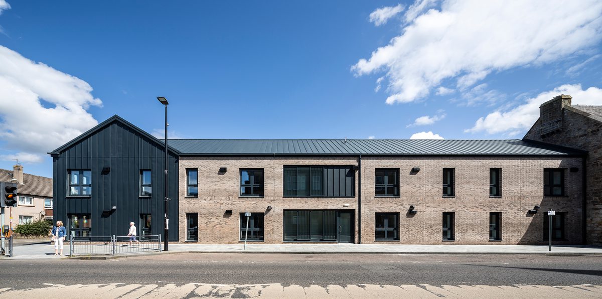 A wide shot of the exterior of 1 - 21 St Cuthbert's on a sunny day with pedestrians in the foreground.