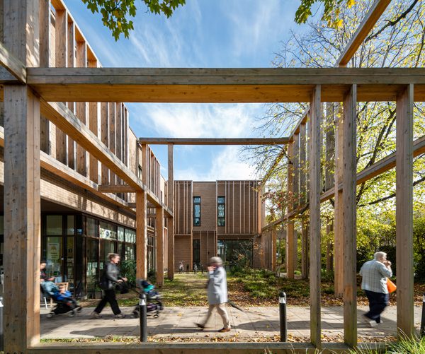 The main entrance view of Abbey Area Community Hub from the side with people leaving and entering the building.