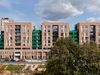 Elevation of Acton Gardens development showing the landscaped surrounding area on a sunny day.