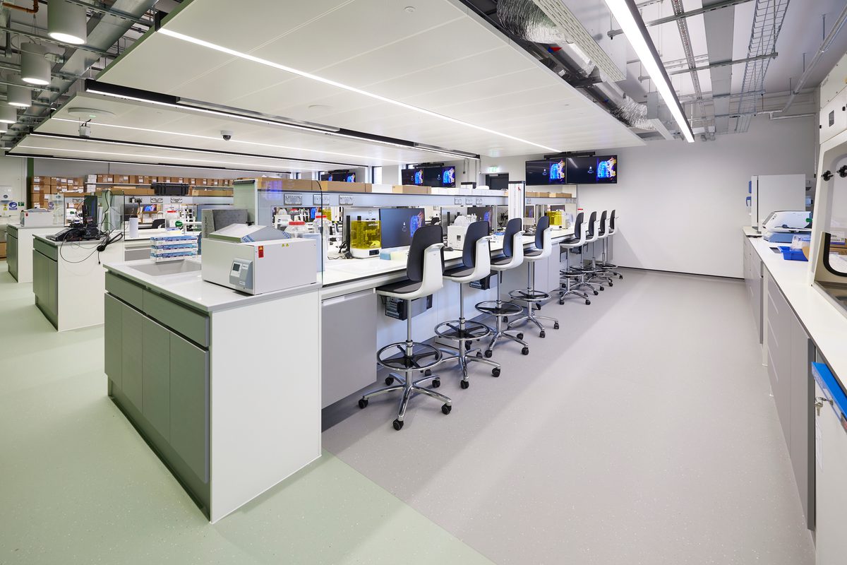 The vast laboratory space with workspace, chairs and equipment in a brightly lit room.