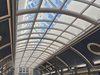 The refurbished glass rooflight and curved metal fixtures, within the atrium of Bacup and Rawtenstall Grammar School.