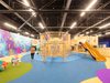 Children and adults playing inside the colourful soft play area inside Barnsley Metrodome Adventure Reef.