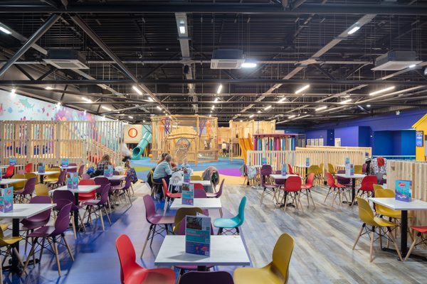 The indoor seating area with vibrant colours and various options to sit down.
