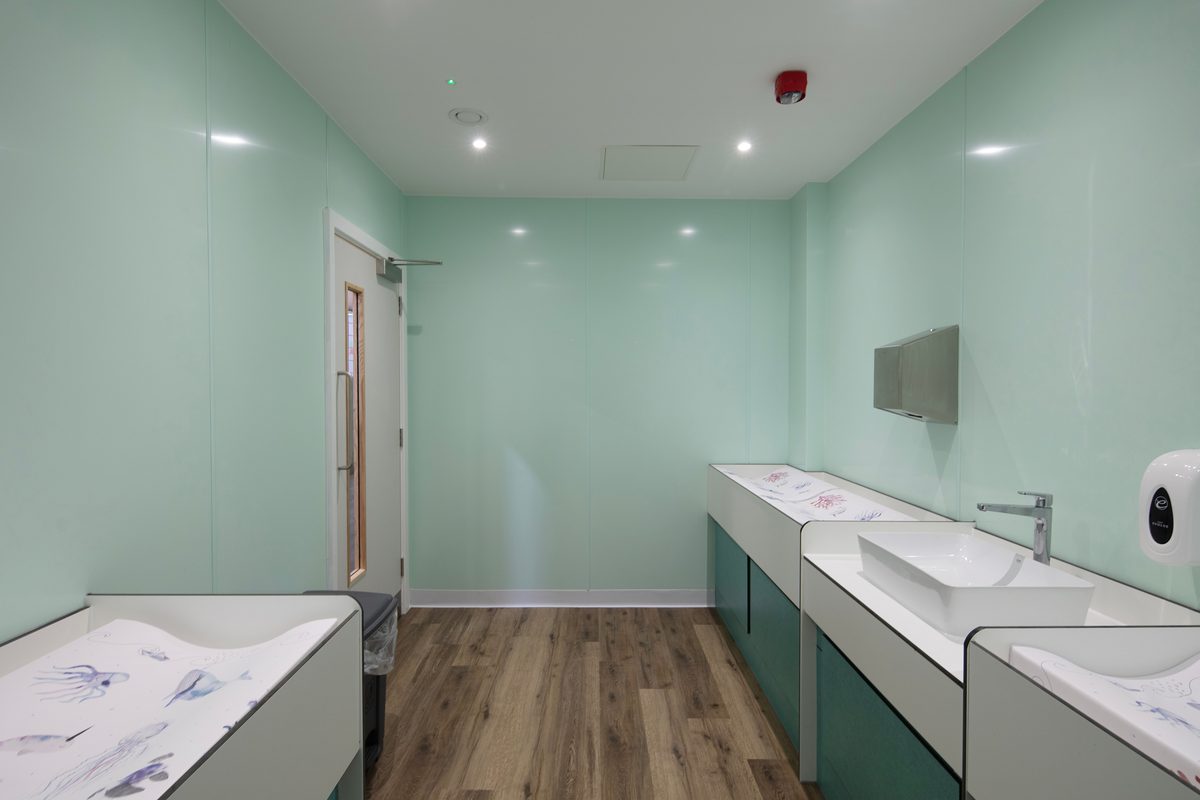 The indoor changing facilities at Barnsley Metrodome Adventure Reef with a changing table and sinks.