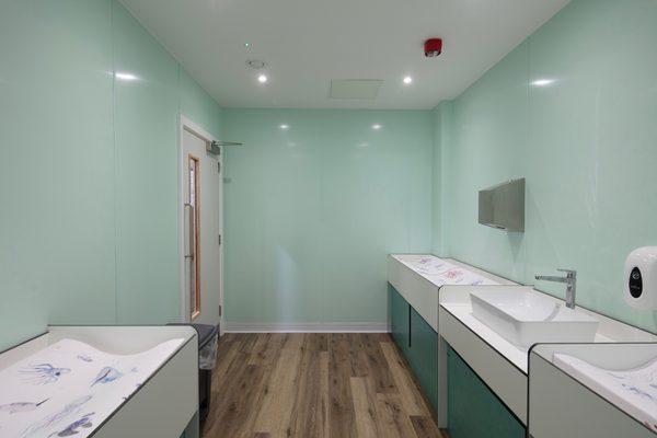 The indoor changing facilities at Barnsley Metrodome Adventure Reef with a changing table and sinks.