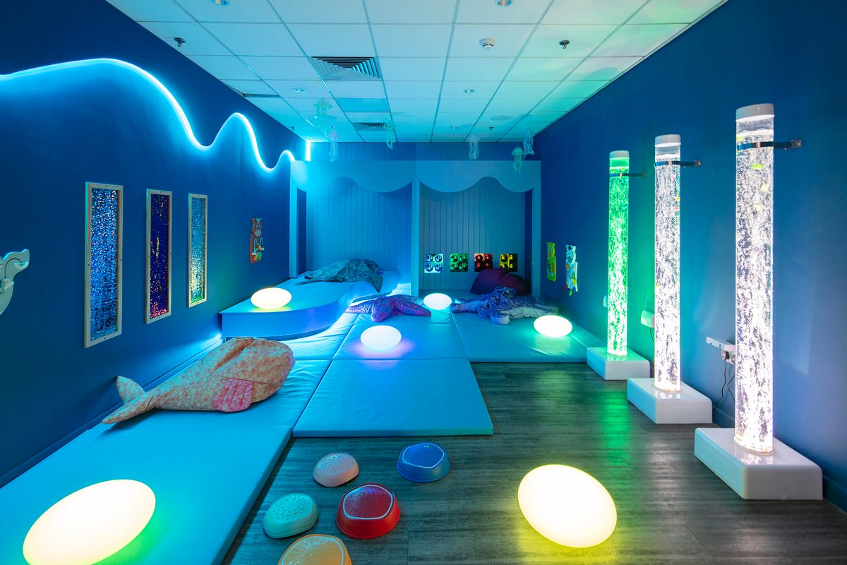 A colourful and vibrant sensory room with various lights and toys inside the Adventure Reef at Barnsley Metrodome.