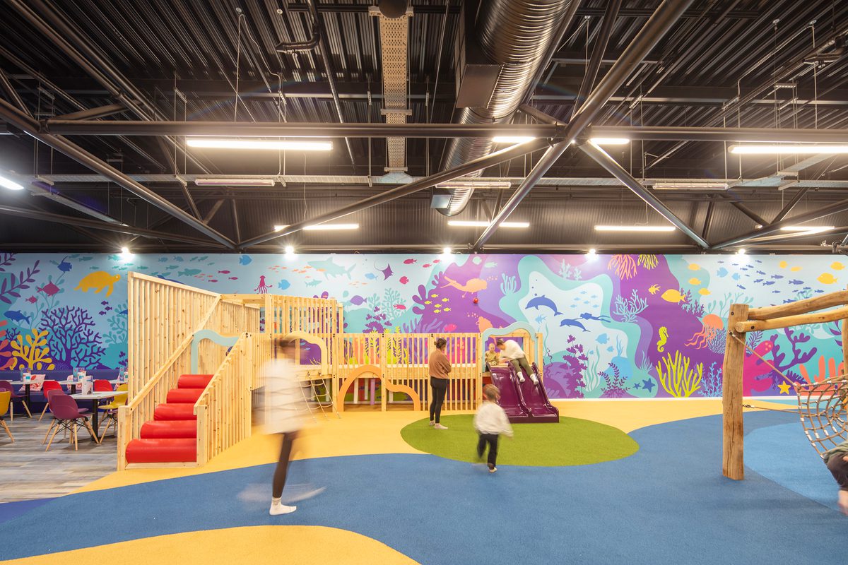People and children playing inside the indoor soft area at Barnsley Metrodome Adventure Reef.