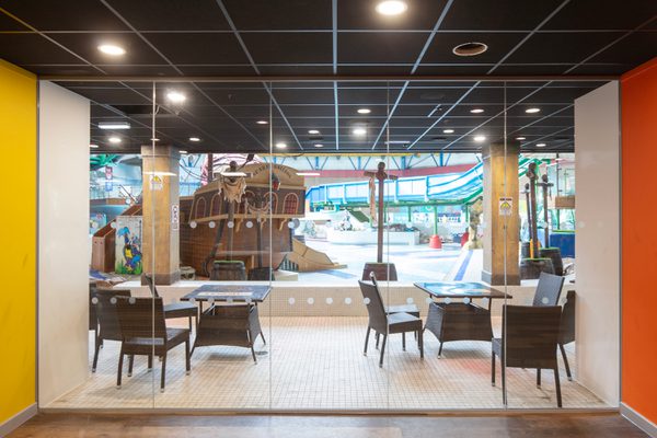 The bright reception area within the refurbished Barnsley Metrodome, with coloured columns and floor to ceiling windows providing views onto the swimming area.
