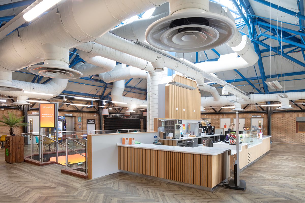 The café facilities within the bright reception area within the refurbished Barnsley Metrodome, with roof lighting and wooden detailing.