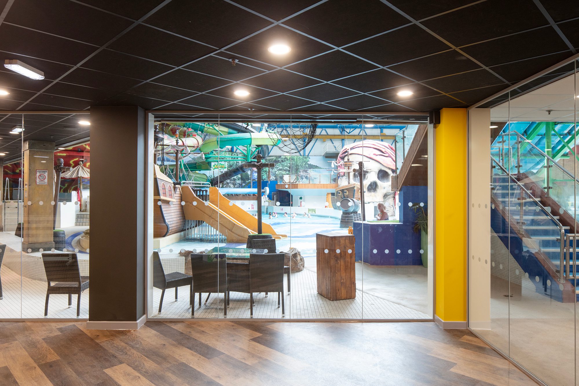 Glazed poolside partitions brighten the space