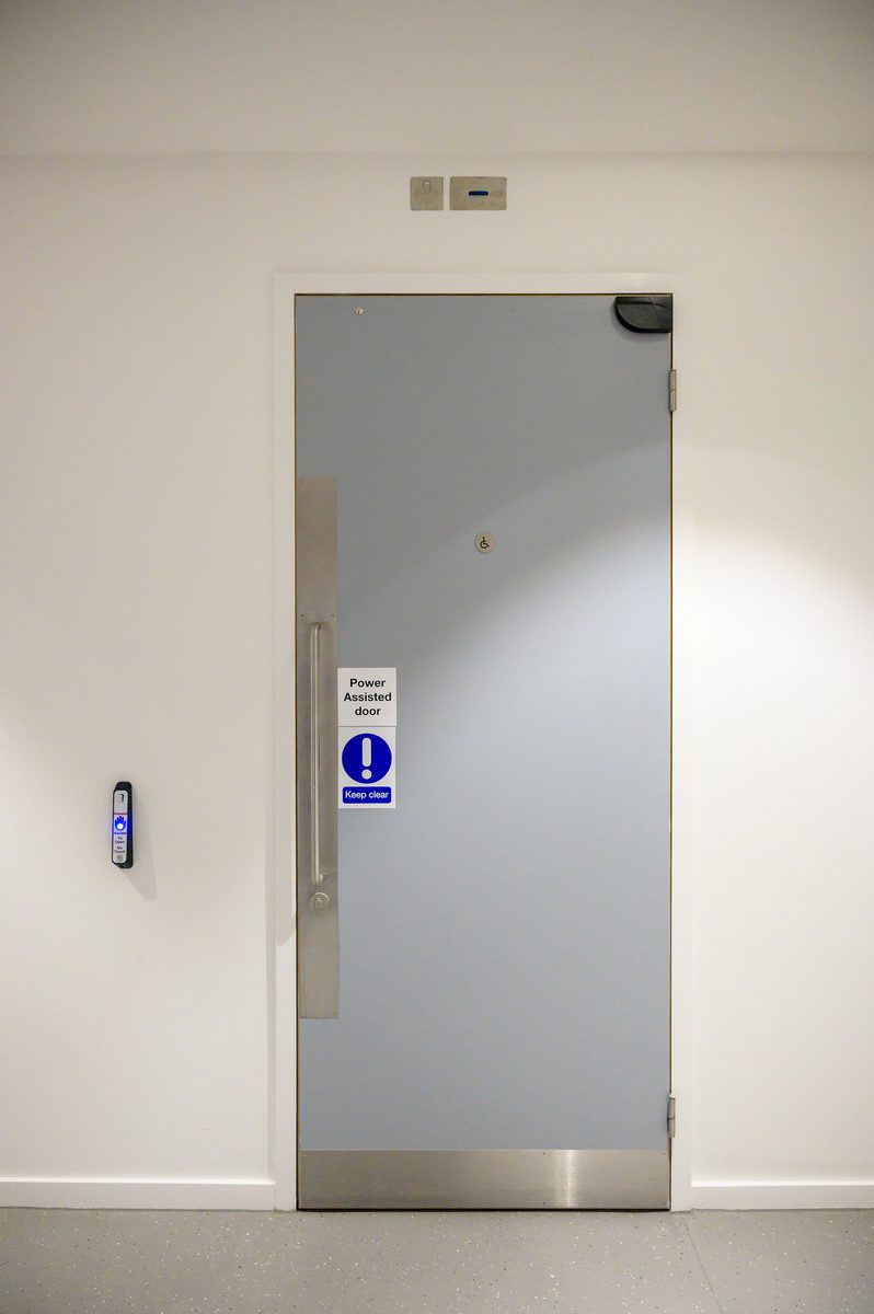 A grey power assisted door within the Children and Family Court Advisory and Support Service office.