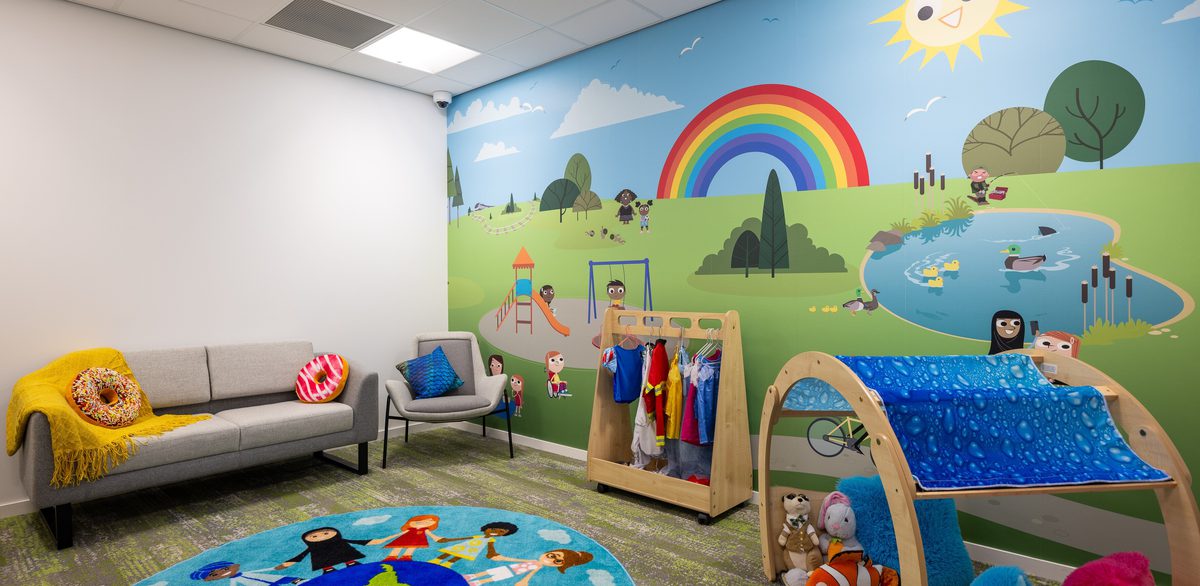 The bright, family play space within the Children and Family Court Advisory and Support Service office, with colourful wall graphics and toys.