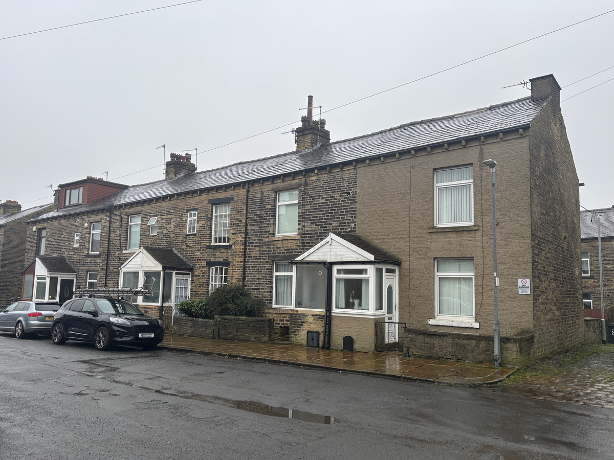 A row of houses on a street with cars in view, part of Calderdale Council's Healthy Homes project.