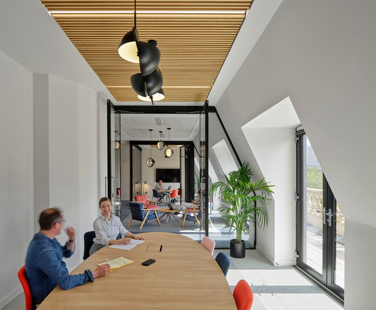 Two people working collaboratively in a bright shared work space within the Chatwin building.
