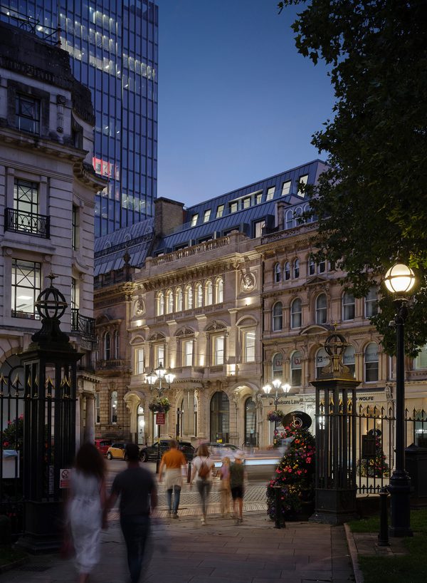 Evening view of the illuminated Chatwin Building on Colmore Row showing Victorian facade and streetscape.