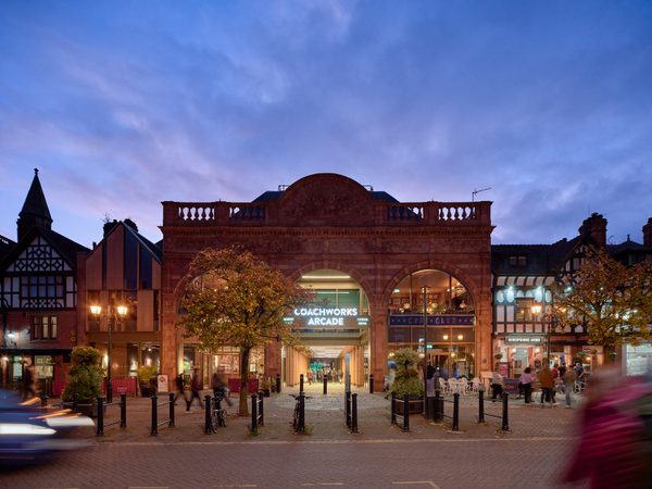 An exterior shot of the refurbished listed market at dusk, showing the preserved heritage features of the hall.