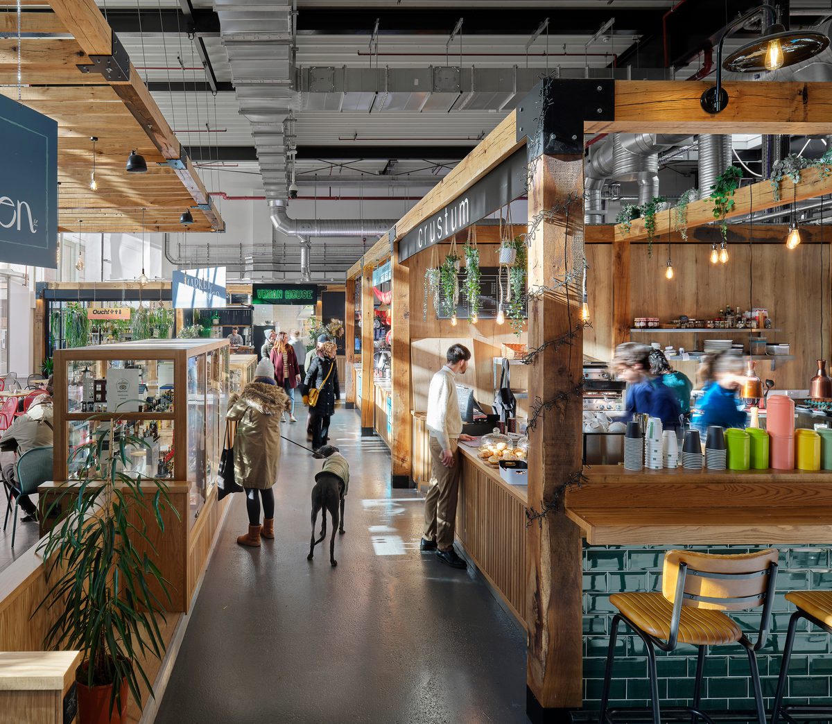 People enjoying the bright, modern market hall of the Chester Northgate development.