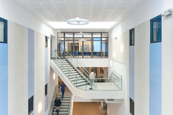 People walking up and down the staircase in the entrance to the Women and Children's Building.