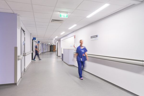 A staff member walking down the curved corridor.