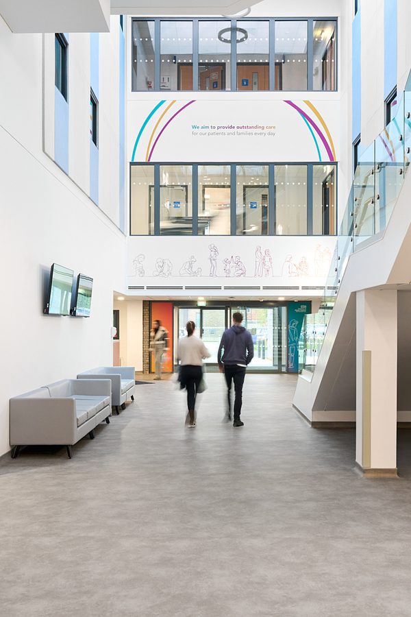 A couple approaching the Women and Children's Building bright entrance.