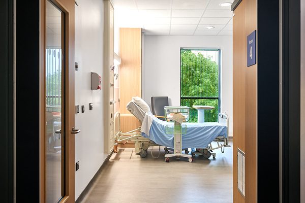 A maternity suite with views out the window showing trees and greenery.