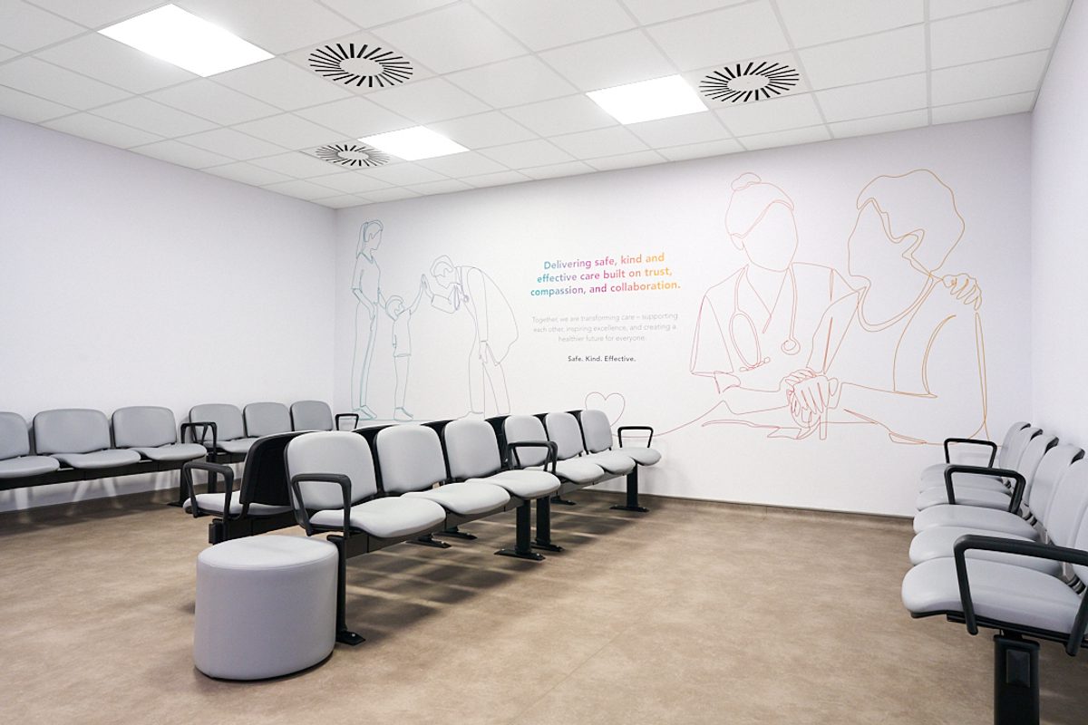 A waiting area inside the Women and Children's Building with a mural painting on the wall.