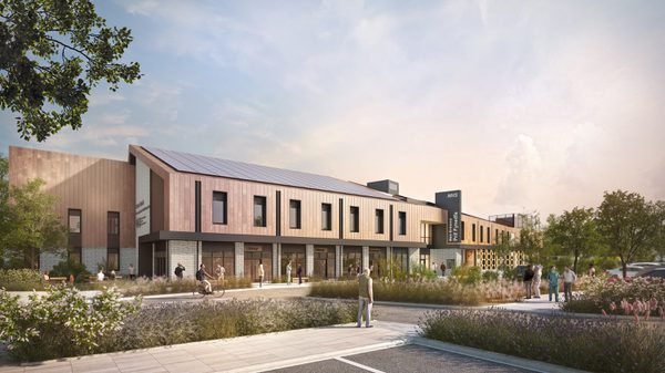 An exterior visualisation of the Cross Hands Community Health and Wellbeing Centre with landscaped parking facilities in front.