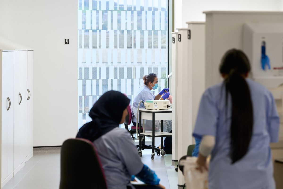 Podiatry students learning in a real-life clinic inside the Daphne Steele Building.