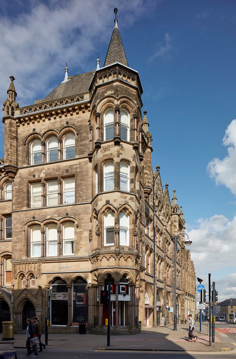 A corner of an ornate exterior of a historic Italianate Gothic, Grade II* Listed building within Huddersfield city centre.