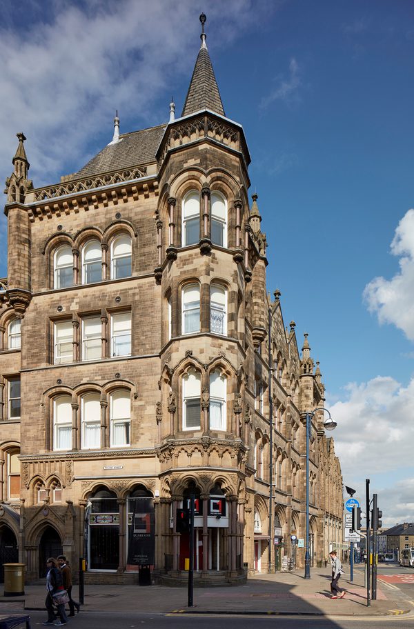A corner of an ornate exterior of a historic Italianate Gothic, Grade II* Listed building within Huddersfield city centre.