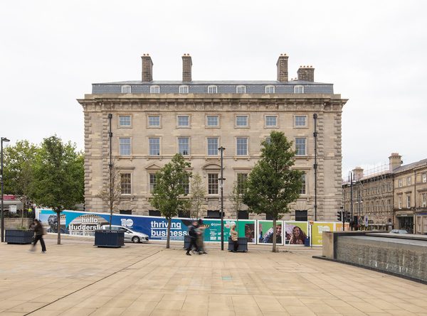 The ornate front of the refurbished and restored Grade II listed George Hotel, showing its city centre location.