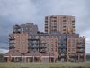 An exterior visualisation of the Glengall Road development showing four interlinked blocks, with a distinctive brick warehouse-style frontage.