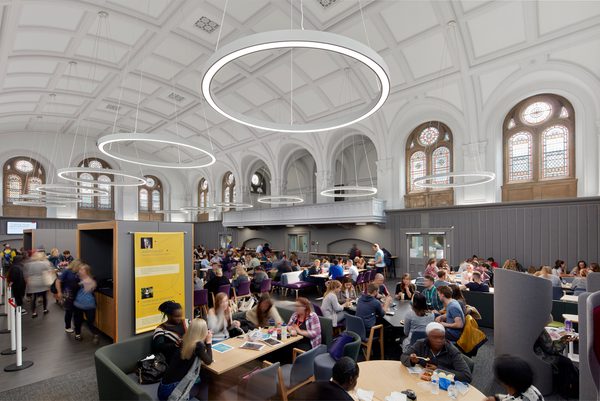 Students enjoying the dining space in the refurbished Traders cafe, with original stone features and windows and bright modern, bespoke lighting.