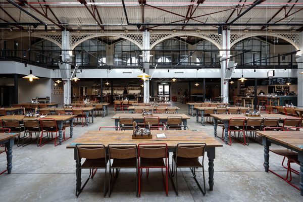 The vast indoor dining and social space at Glossop Town and Market Hall with natural light filling the room.