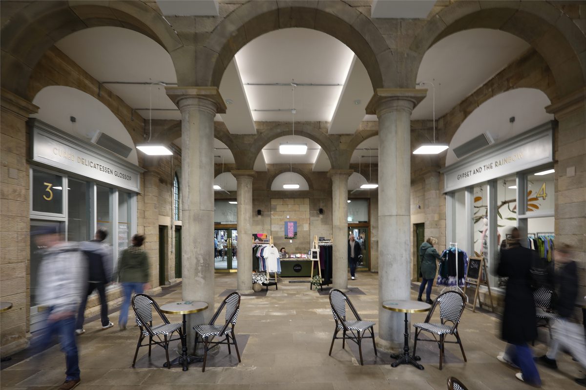 The outdoor courtyard space at Glossop Town and Market Hall featuring ornate columns reflecting the heritage of the site.
