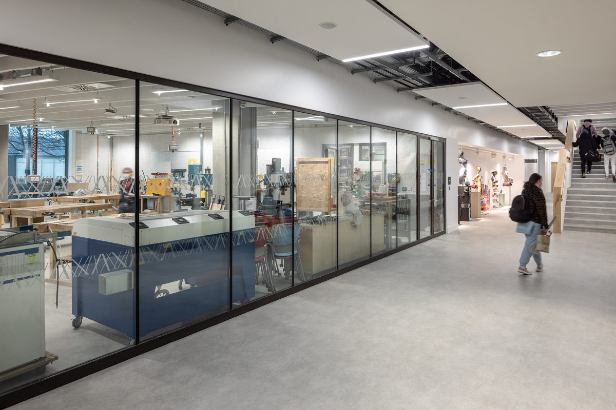 Workshop area in the East Quad Building, with an open plan layout viewable from the corridor as students move through the space.