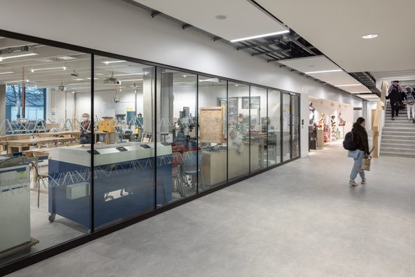 Workshop area in the East Quad Building, with an open plan layout viewable from the corridor as students move through the space.