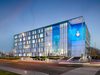 Night view of Greater Manchester Police Force HQ with internal lighting illuminating the glazed facade.