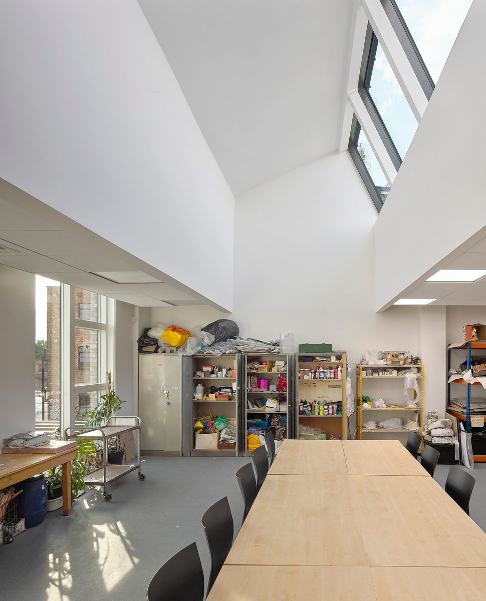 A tall interior view of the arts and crafts room in the greenwood centre with sunlight beaming through the ceiling windows.