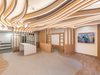 The bright, airy reception interior of the Guy's and St Thomas' Cancer ward, with white oak finishes and locally commissioned artwork on the walls.