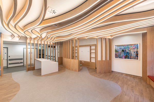 The bright, airy reception interior of the Guy's and St Thomas' Cancer ward, with white oak finishes and locally commissioned artwork on the walls.