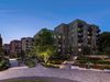 CGI of exterior of the apartments within the Hemel Hempstead former Gasworks development, with pedestrian routes and gardens at night.