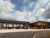 An exterior shot showing the Hicks Gate Fire Station in it's entirety, with striking grey anthracite corrugated metal cladding contrasting with bright timber.