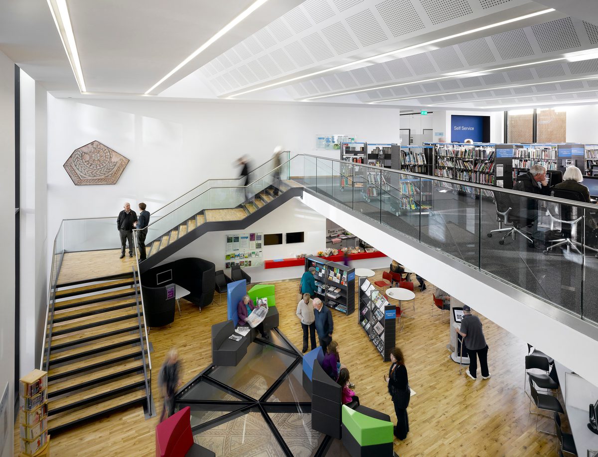 The library within Keynsham Civic Centre and One-Stop-Shop, with mezzanine level and historic Roman mosaic incorporated into the floor.