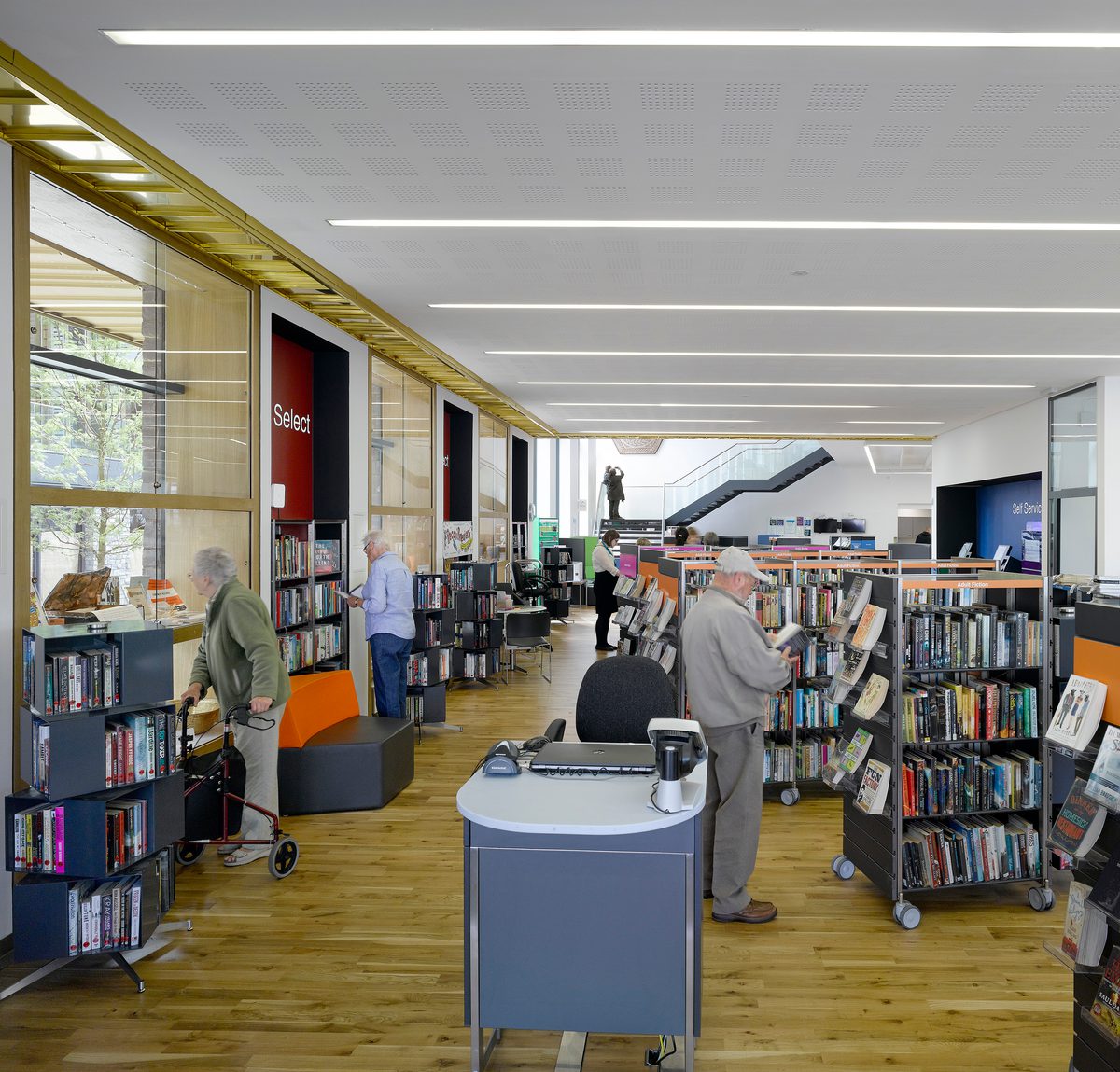 People using the library space within Keynsham Civic Centre and One-Stop-Shop.