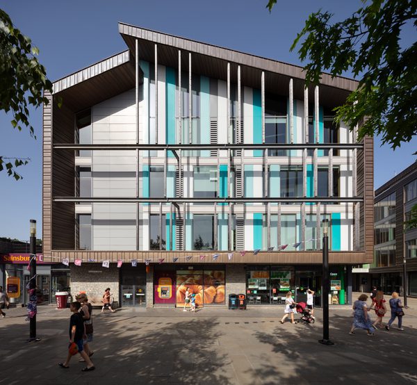 An exterior front view of Keynsham Civic Centre and One-Stop-Shop with surrounding public realm and retail spaces.