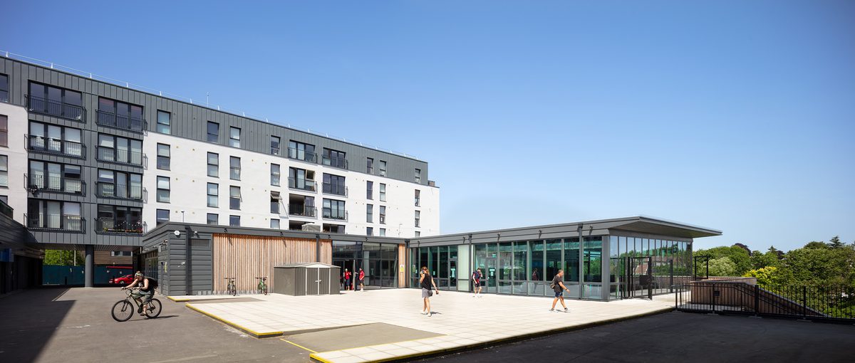 People walking around the outdoor courtyard at the entrance to Keynsham Riverside Leisure Centre.