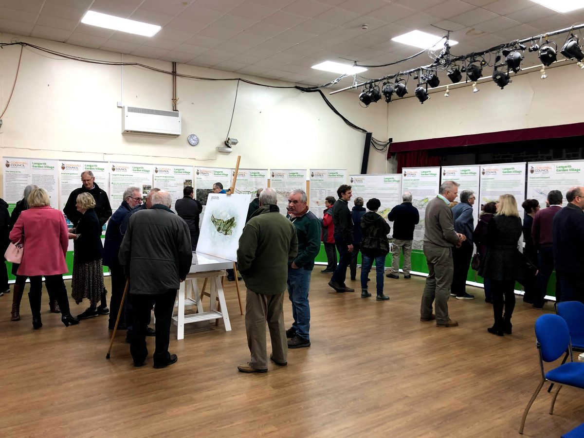 A room full of people surrounded by visual boards as part of the stakeholder engagement process for planning Langarth Garden Village.